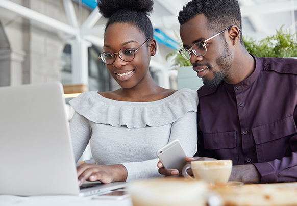 A couple looking at their computer