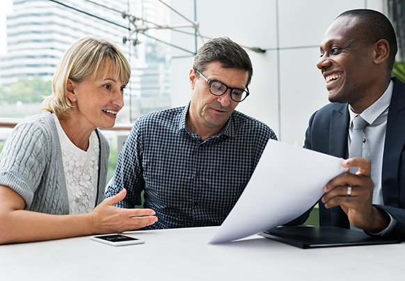 A couple meeting with an insurance agent in an office