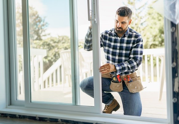 Person installing hurricane strength windows