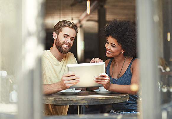 Couple looking at the Citizens' Depopulation Program on their tablet