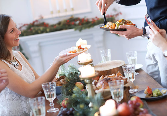 People gathered around food table with candles