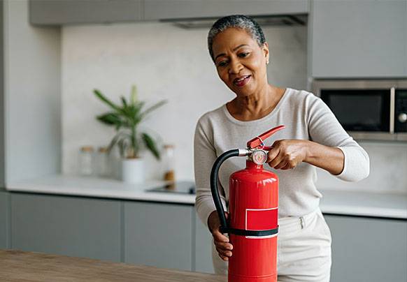woman holding a fire extinguisher