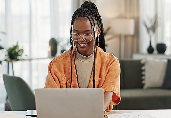 Smiling woman working on laptop
