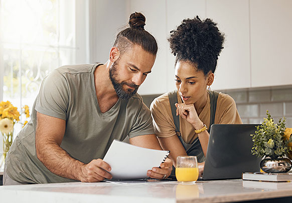 Man and woman reviewing policy documents